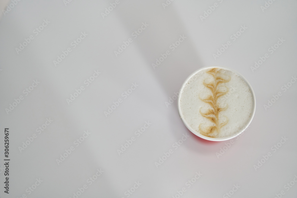 Fototapeta premium red paper cup with coffee in a coffee shop