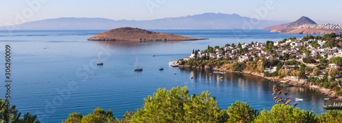 Aegean coast with marvelous blue water, rich nature, islands, mountains and small white houses photo