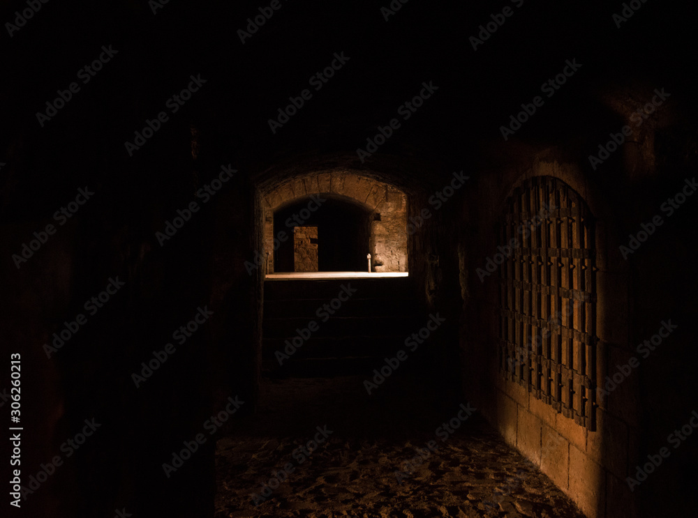 Interesting View from the inside of a dark room dungeon, with natural light entering from outside