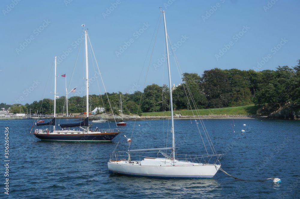 Sailboats moored in the water off the coast of Rhode Island
