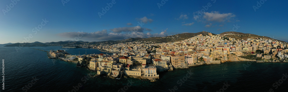 Fototapeta premium Aerial drone photo of pictruesque district built by the sea of Vaporia in main town of Syros or Siros island Ermoupolis near famous church of Agios Nikolaos, Cyclades, Greece