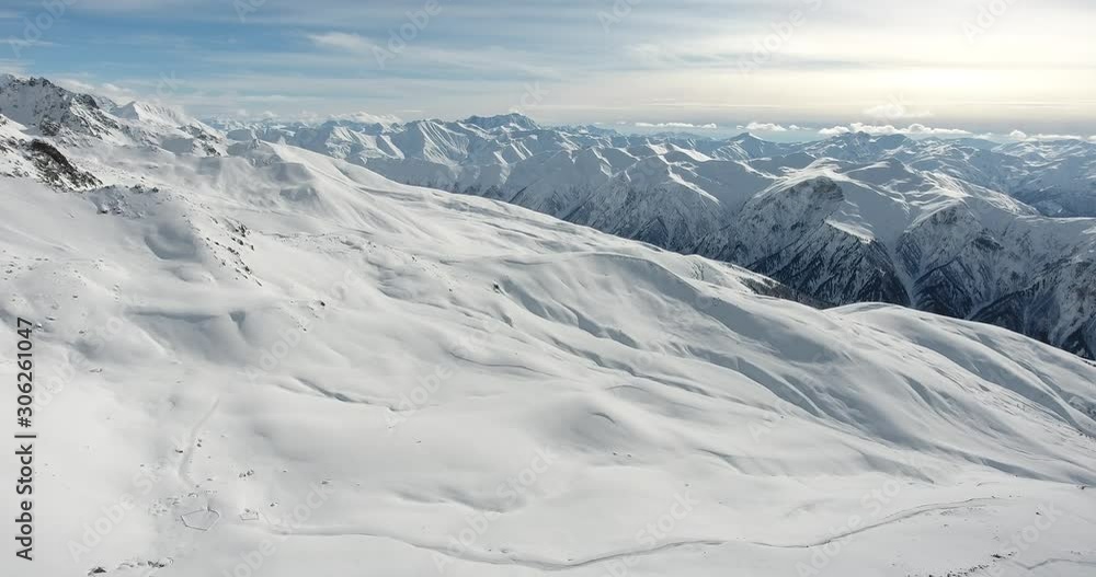 High mountains with fresh snow in sunny winter day. Freeride on off piste slope. Top aerial view. Caucasus Mountains, Georgia, ski, Tetnuldi, Alps. Svaneti High mountains with fresh snow in sunny winter day. Freeride on off piste slope. Top aerial view. Caucasus Mountains, Georgia, ski, Tetnuldi, Alps. Svaneti