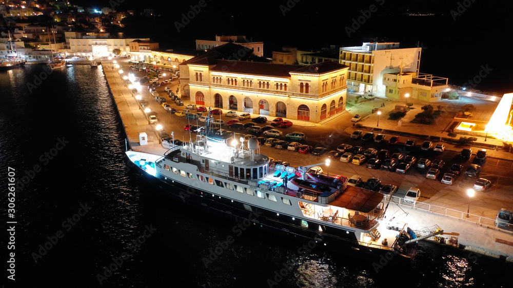 Aerial drone night shot of famous port and illuminated town of Ermoupolis in island of Syros or Siros, Cyclades, Greece Aerial drone night shot of famous port and illuminated town of Ermoupolis in island of Syros or Siros, Cyclades, Greece