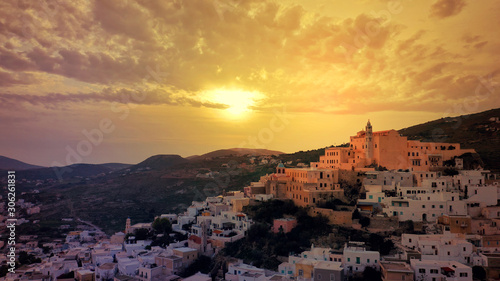 Aerial drone photo of iconic uphill Catholic settlement of ano Syra featuring church of Saint George at sunset with beautiful colours, Syros or Siros island, Cyclades, Greece