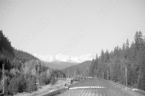 British Columbia, Canada - October 10 2019: Travelling on Via Rail through British Columbia whilst passing a freight train with many carriages on the other rail line.