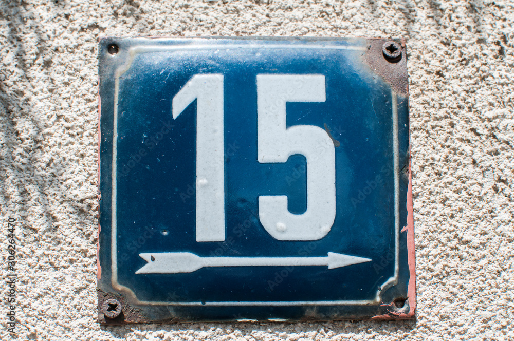 Weathered grunge square metal enameled plate of number of street address with number 15 closeup Weathered grunge square metal enameled plate of number of street address with number 15 closeup