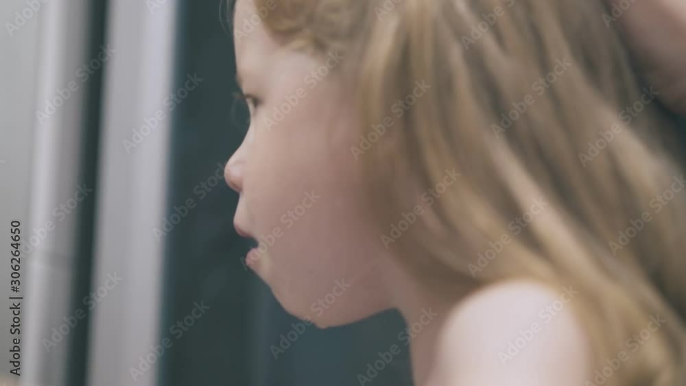 young mommy rinses nose of cute little girl with nasal spray in bathroom at home on blurred background close side view young mommy rinses nose of cute little girl with nasal spray in bathroom at home on blurred background close side view