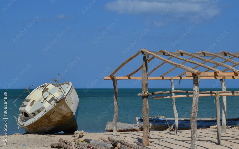 old boat next to a rustic cabin in the middle of the Colombian guajira, northernmost point of South America