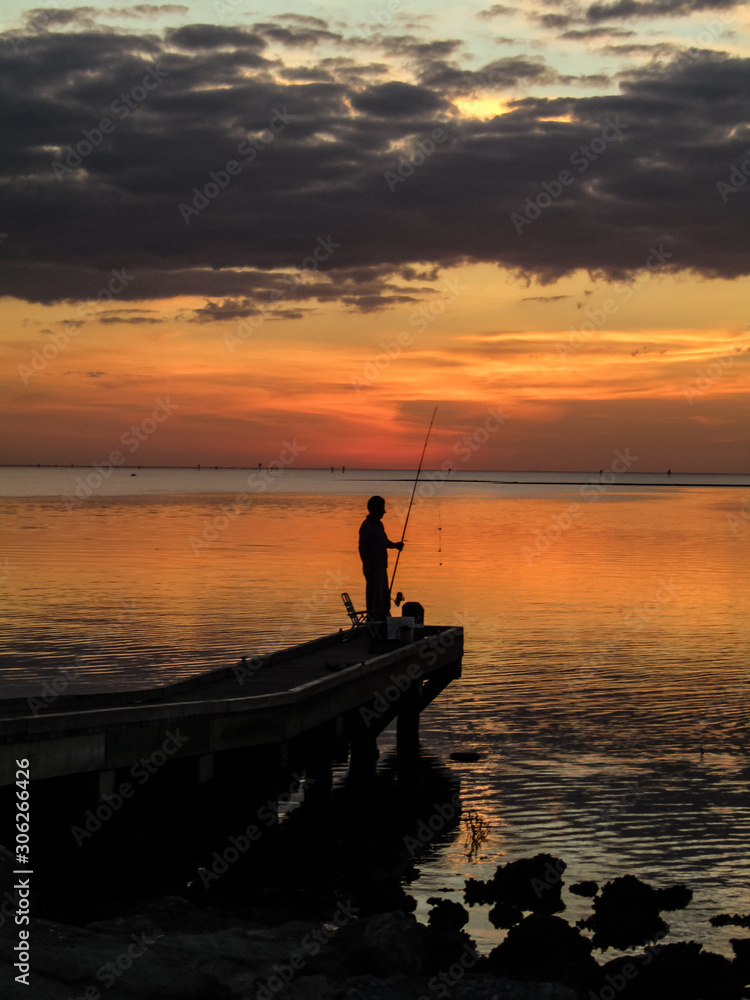 fisherman at sunset on the gulf coast