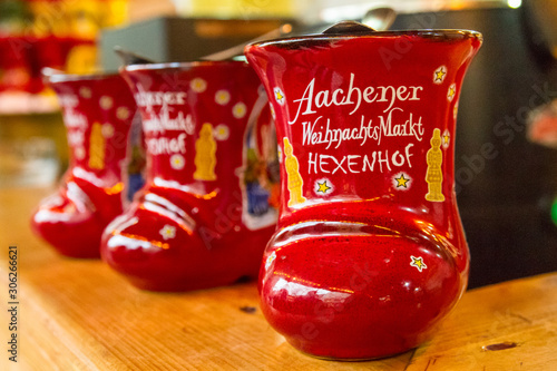 Traditional german holiday alcoholic drink - punch (Feuerzangenbowle) in cup in the form of shoe with German text, translated as - Aachen Christmas Market Hexenhof (restaurant), Aachen, Germany photo