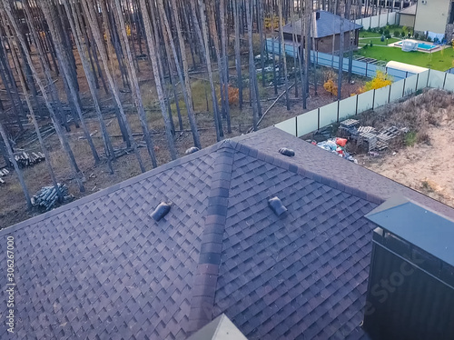 Bituminous tile for a roof. House with a roof from a bituminous photo