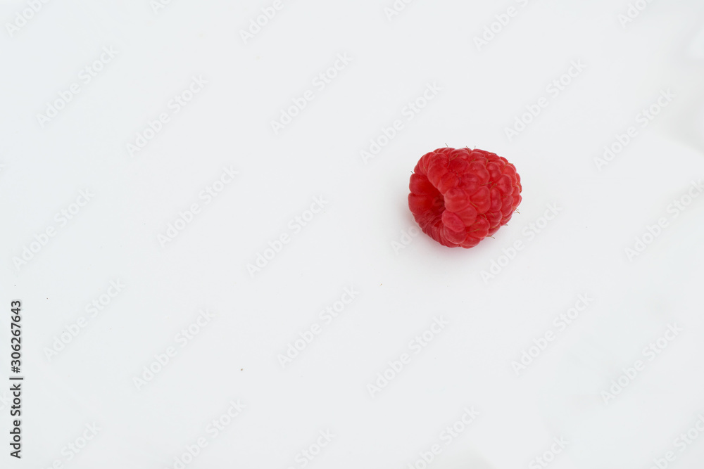 single raspberry against white background single raspberry against white background