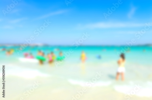Blurred people relaxing on the beach © opasstudio