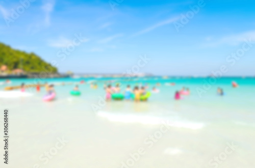 Blurred people relaxing on the beach