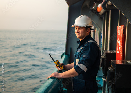 Photographie Marine Deck Officer or Chief mate on deck of offshore vessel or ship , wearing PPE personal protective equipment - helmet, coverall