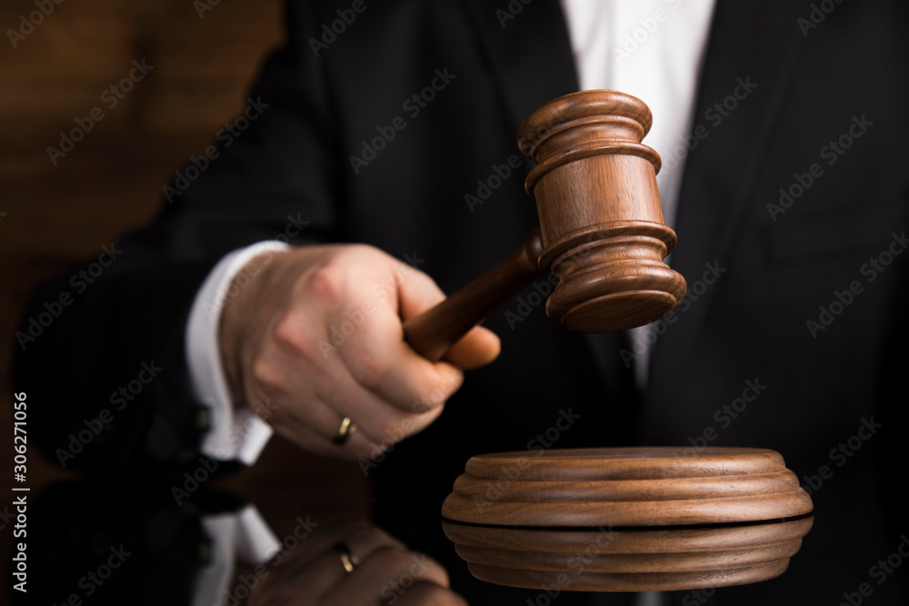Justice and law concept, Male judge in a courtroom striking the gavel Justice and law concept, Male judge in a courtroom striking the gavel