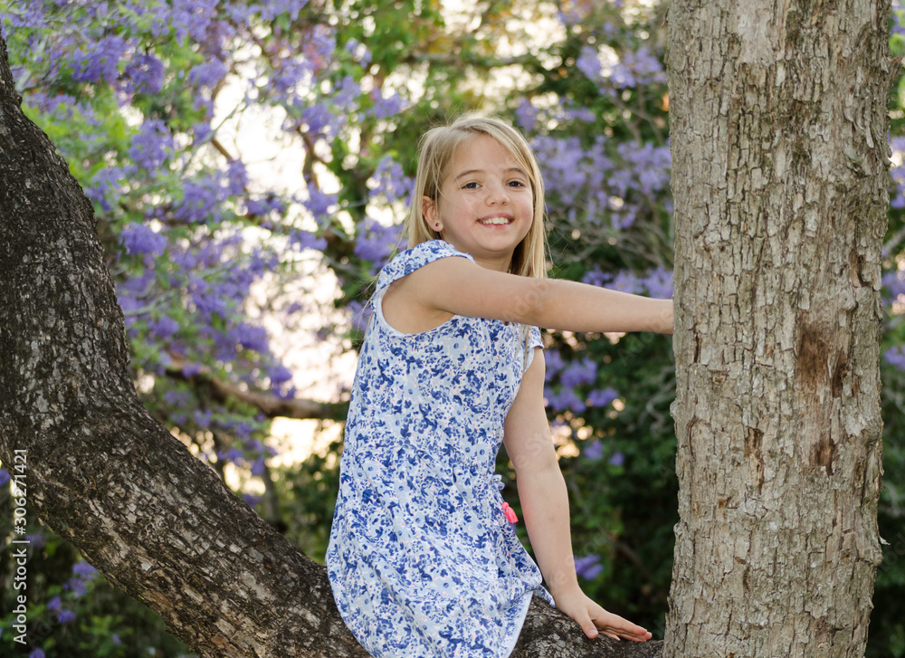 Blonde girl, enjoying nature, outdoor in spring. Jacaranda trees Blonde girl, enjoying nature, outdoor in spring. Jacaranda trees
