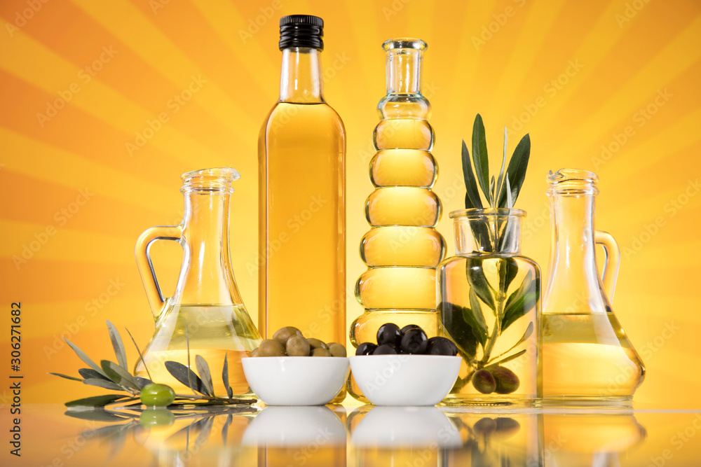 Bottles with organic cooking olive oil and olive branch Bottles with organic cooking olive oil and olive branch