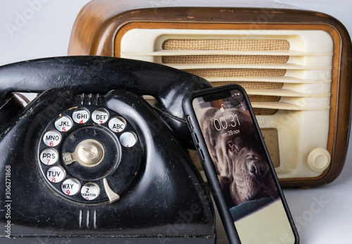 50s telephone and radio and modern smart phone