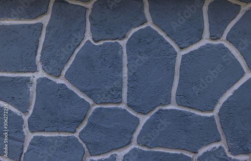 Light blue stone wall. With white lines divided into compartments. Texture background has an artistic pattern.