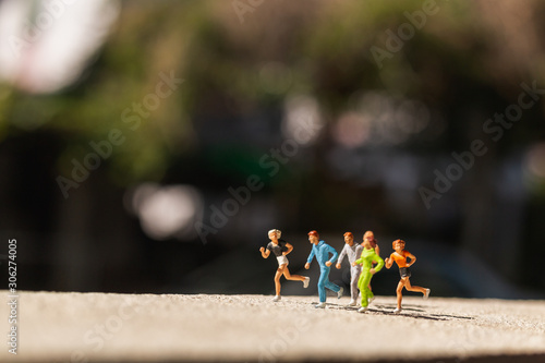 Miniature people   Group of people are running  on concrete road    Healthy and lifestyle concept