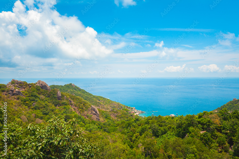 Natural Landscape View of Stone Mountain and Tropical Beach against Blue Sky and Clouds