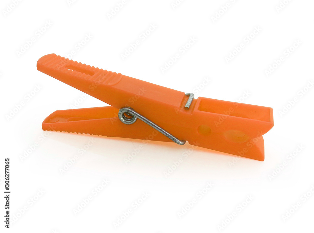 Horizontal view. Isolated orange plastic clothespin on white background. Horizontal view. Isolated orange plastic clothespin on white background.