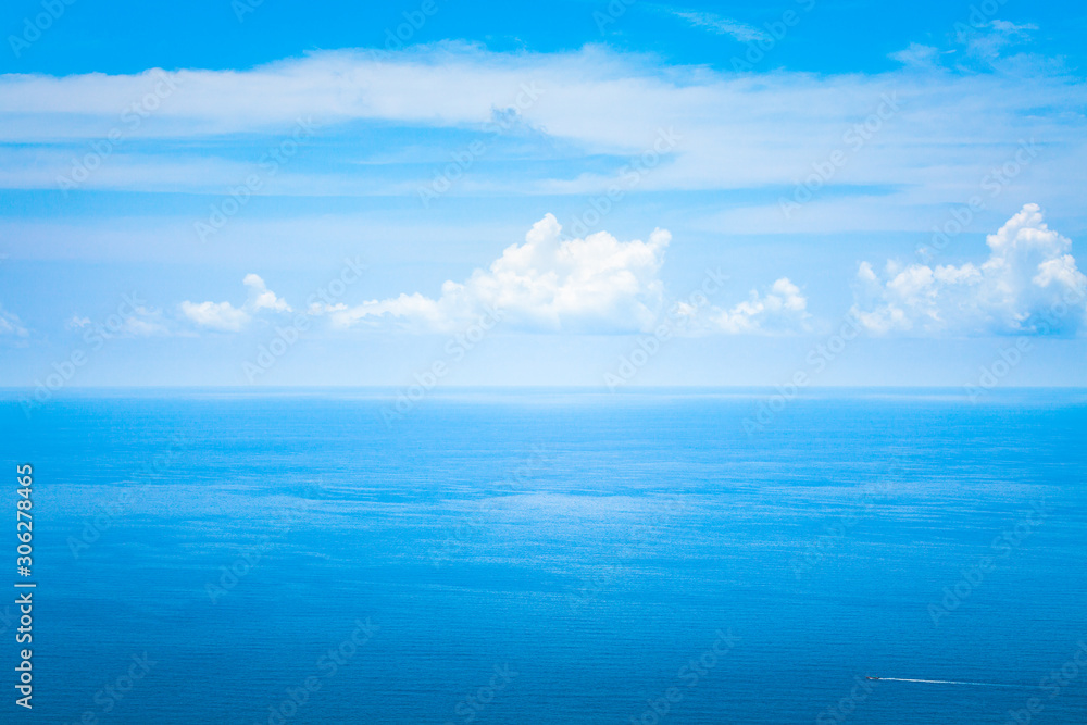 Background Texture of Ocean Skyline with Tropical Beach against Blue Sky and White Clouds in Summer Sunny Day