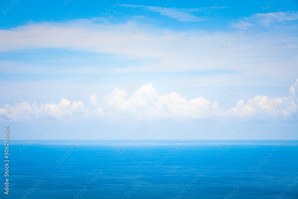 Background Texture of Ocean Skyline with Tropical Beach against Blue Sky and White Clouds in Summer Sunny Day