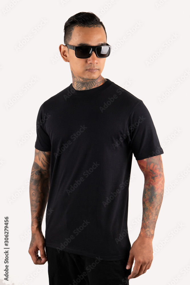 Six Pack man tattooed wearing black t-shirt short sleeve isolated on plain background Six Pack man tattooed wearing black t-shirt short sleeve isolated on plain background