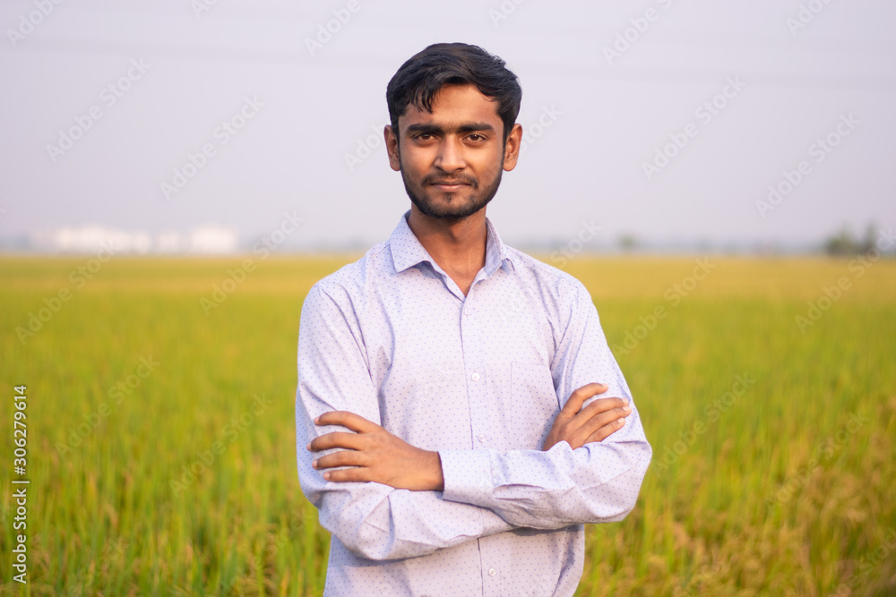 Portrait of young Indian Farmer wearing formal dress in green paddy field. Portrait of young Indian Farmer wearing formal dress in green paddy field.