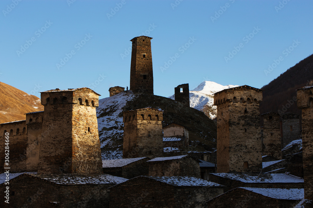 Ancient watchtowers of Svaneti Georgia on a background of snowy mountain peaks.