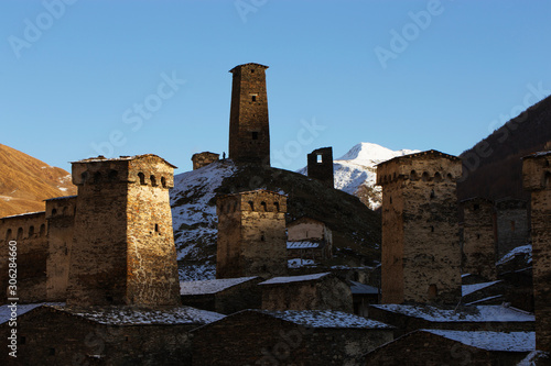 Ancient watchtowers of Svaneti Georgia on a background of snowy mountain peaks.
