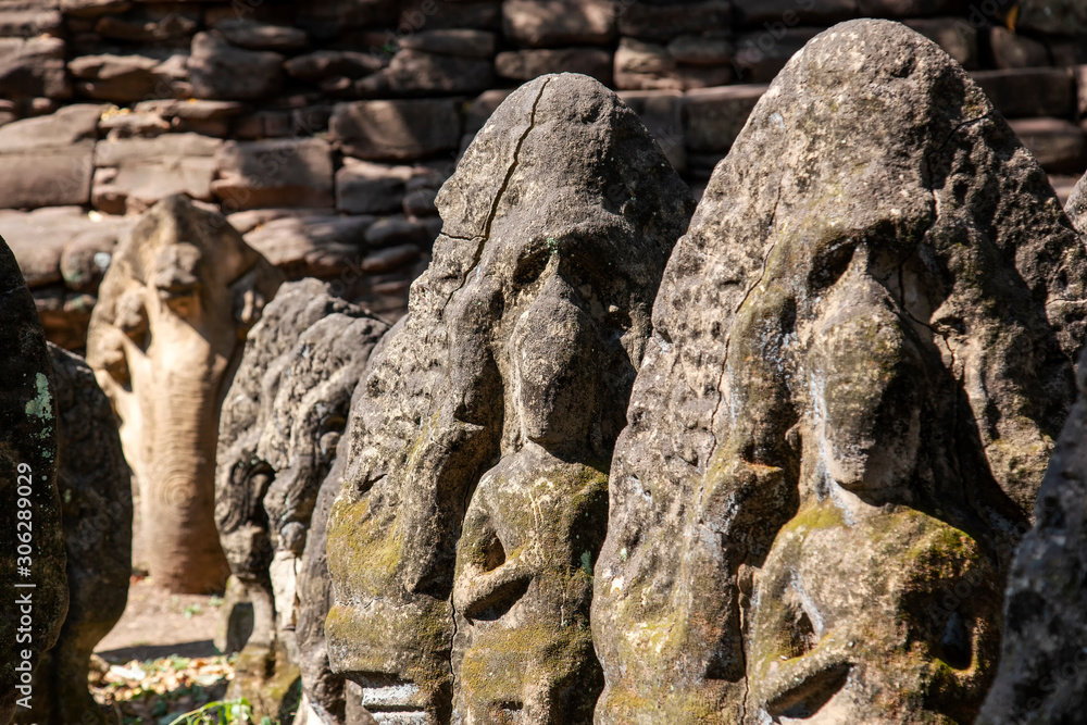 The antique sandstone statue carving Khmer art at Phimai castle historical park.