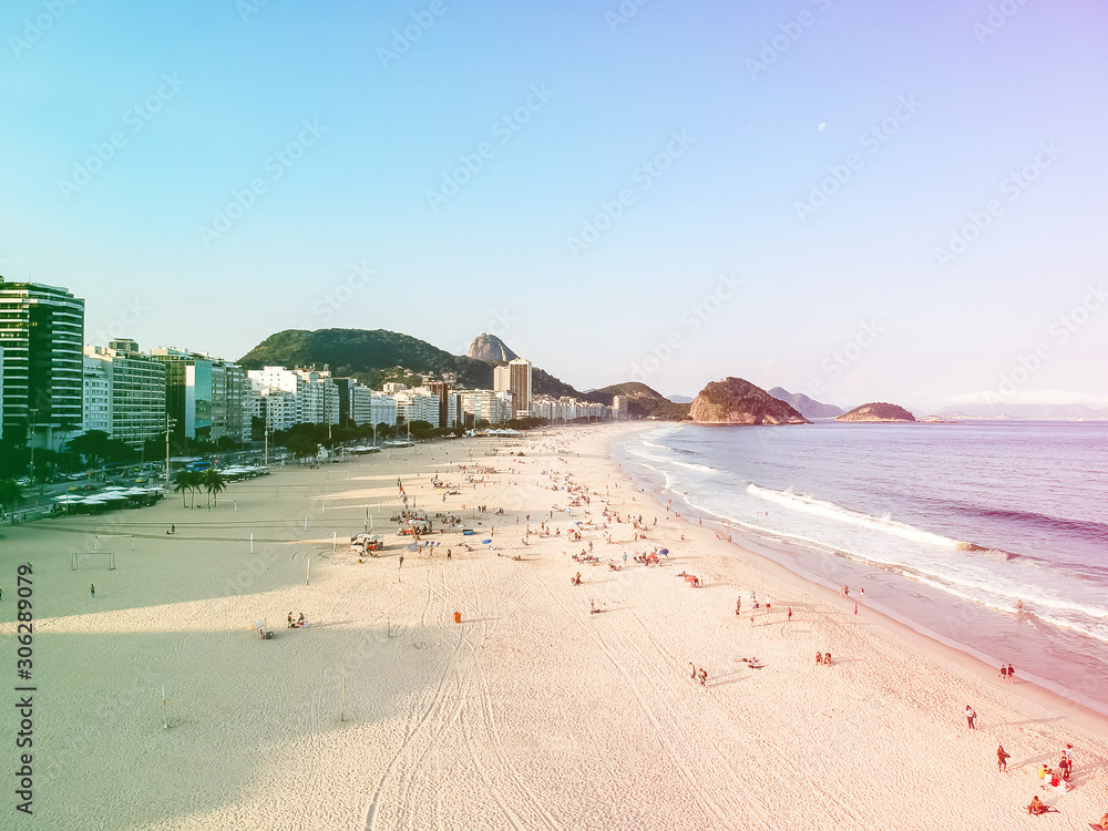 aerial drone view of Copacabana beachs during late afternoon,, some shadows can be seen on the sand. Rio de Janeiro, Brazil. Colored light leak aerial drone view of Copacabana beachs during late afternoon,, some shadows can be seen on the sand. Rio de Janeiro, Brazil. Colored light leak