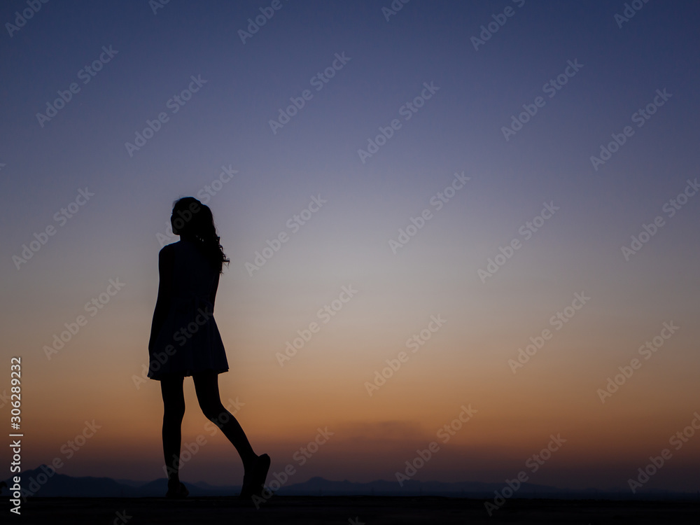 silhouette of young woman freedom feeling at sunset,thinking