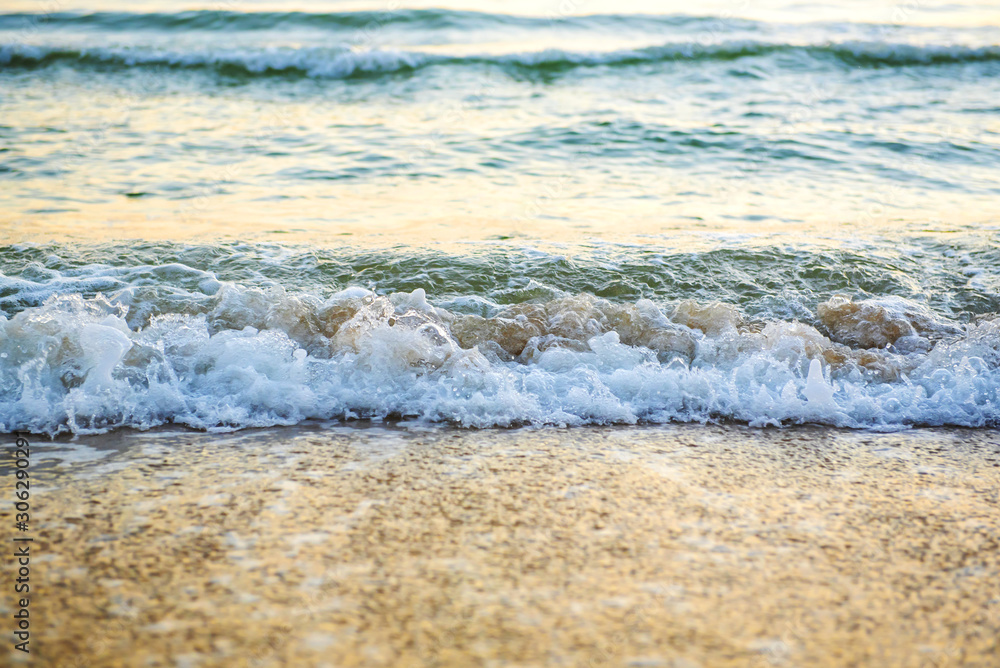 The sea with waves hit the sandy beach in the morning, with copy space text The sea with waves hit the sandy beach in the morning, with copy space text