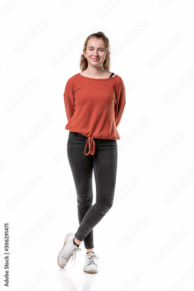 A beautiful caucasian generation z girl standing in casual clothes with her feet crossed isolated on a white background A beautiful caucasian generation z girl standing in casual clothes with her feet crossed isolated on a white background