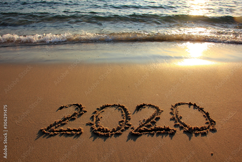 Happy New Year 2020 is coming concept on the sunset and tropical ocean beach lettering. Happy New Year 2020 is coming concept on the sunset and tropical ocean beach lettering.