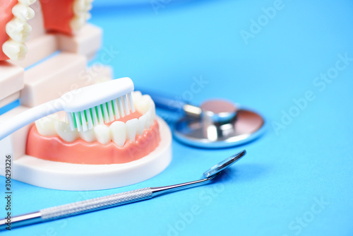 Dental care concept - dentist tools with dentures dentistry instruments and dental hygiene and equipment checkup with teeth model and mouth mirror oral health photo