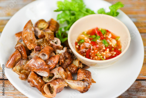 Roasted pork Chitterlings with chilli sauce spicy - entrails intestines part of pork asian thai food