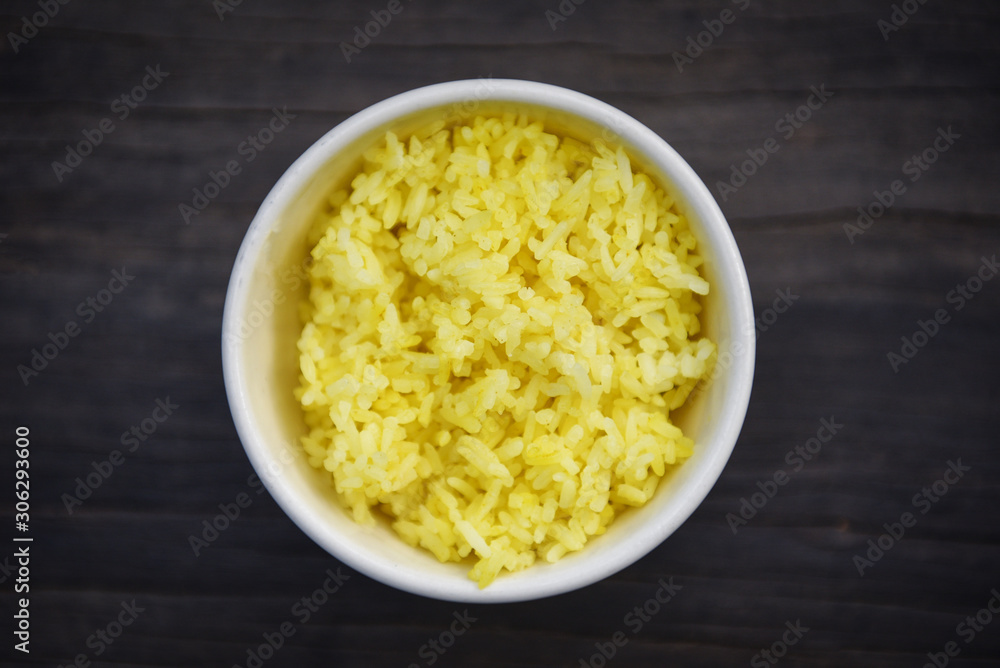 Cooked yellow rice in a bowl / rice turmeric food Cooked yellow rice in a bowl / rice turmeric food