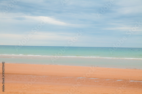 Coastal beach landscape scene of sand and water