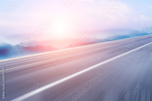 Seaside highway, distant mountain as the background material for the car advertisement. © hqrloveq