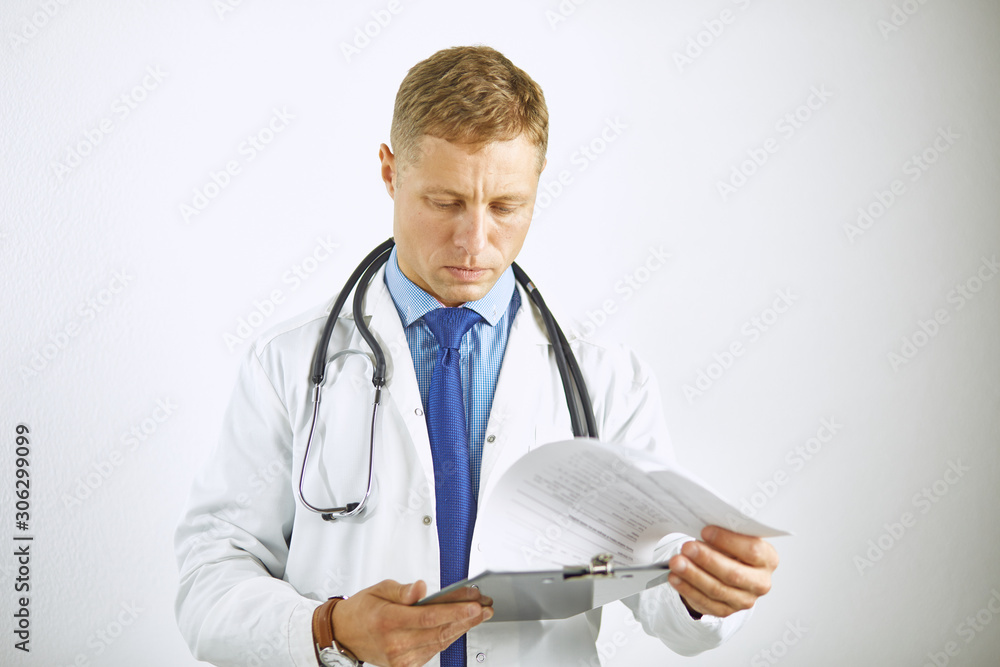 Young confident doctor in a white coat with a stethoscope