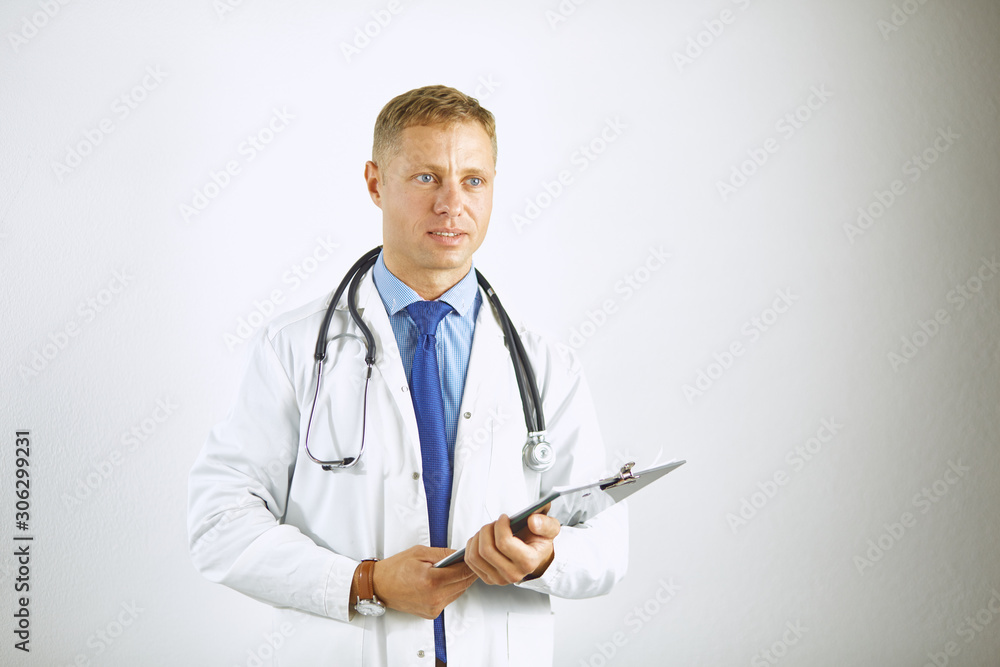 Young confident doctor in a white coat with a stethoscope Young confident doctor in a white coat with a stethoscope