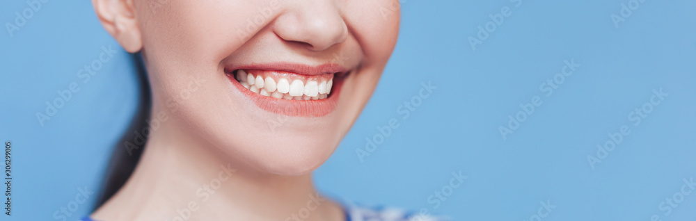 © Anastassiya - Smiling woman mouth with white healthy teeth on blue background. © Anastassiya - Smiling woman mouth with white healthy teeth on blue background.