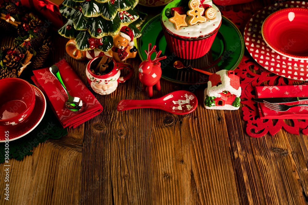 Christmas time. Christmas tableware and decorations. Red and brown colors. Rustic wooden background.