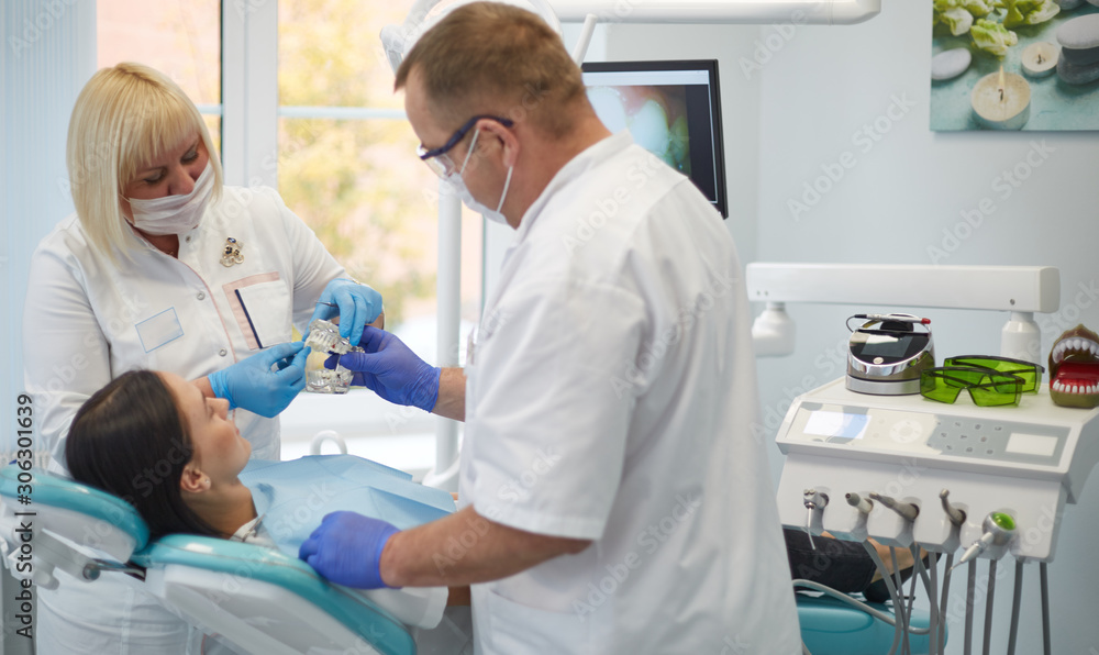 Doctor dentist treats teeth of a beautiful young girl patient. Doctor dentist treats teeth of a beautiful young girl patient.