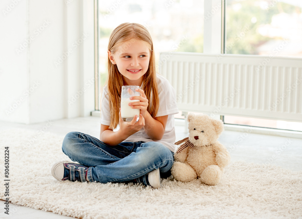 Girlie sits with cup of milk Girlie sits with cup of milk